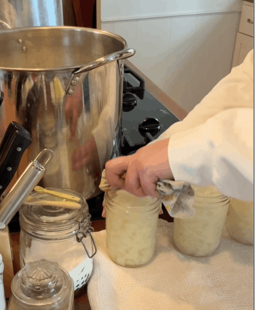 wiping the rims of canning jars for pressure canning onions